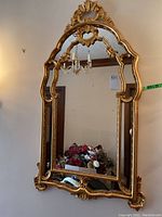 Full front view of mirror mounted on wall, showing entire frame and reflective surface