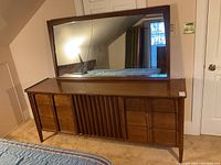 Front view of walnut dresser/credenza with rectangular mirror on top