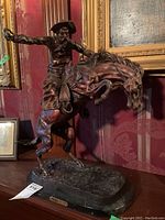 Full view of sculpture showing rider and horse on base