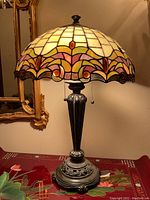 Full front view of the lamp on dresser showing shade, base, and environment