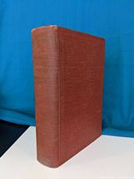 Front angle view of the hardcover reddish-brown book showing spine with title 'Family Mark Twain'.
