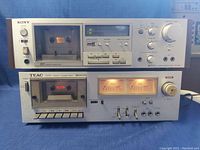 Sony TC-K61 and Teac CX-310 vintage stereo cassette decks stacked, showing cassette compartments, buttons, knobs, and VU meters.