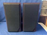 Front view of both speakers with black grills on