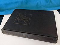 Black hardcover book front cover with gold embossed design