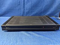 Front and top view of the black Elan Z Series Class A power amplifier with ventilation slots on top and power LED on front panel.