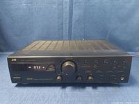 Front view of JVC RX-318 stereo receiver showing tuner, knobs, and buttons.
