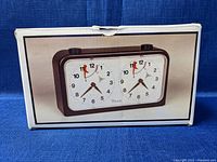 Chess clock in its original box showing front view on packaging.