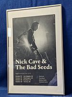 Framed poster with image of Nick Cave performing and tour dates text