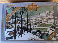 Photo of the puzzle box top showing the artwork "The Hunters in the Snow" by Pieter Bruegel, indicating 2000 pieces and 200th Anniversary edition.