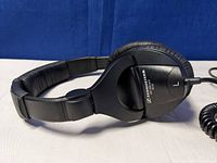 Side view of the left ear cup with model markings and part of the padded headband.