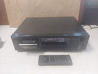 Front view of Sony DTC-75ES DAT deck with display showing OPEN, headphone jack, control buttons and included remote
