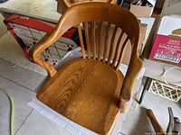 Top view showing the curved wooden backrest with vertical slats and contoured oak seat.