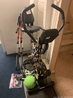 Pro Form X Duo exercise bike with walking poles, helmets, air pump and skipping rope visible on bike base