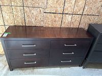 Front view of Bühler six-drawer wood dresser with metal handles, dark finish, showing drawer layout and surface condition.