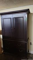Front view of dark brown solid wood wardrobe armoire