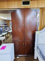 Front view of the wooden wardrobe showing 4 doors and the base drawers.