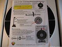 Assembly instruction sheet showing detailed steps to attach base, support post, and wheel with hardware and instructions to install pegs and use the dry chalk marker.