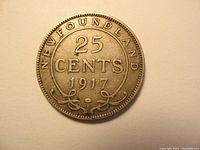 Reverse side of 1917 Newfoundland 25 cents silver coin showing denomination, date, and lettering with floral design.