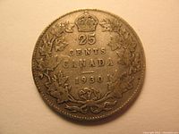 Reverse side of the coin with denomination 25 cents, year 1930, and maple leaf wreath design.