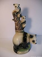 Front-side view of the pandas liquor decanter showing momma panda and cubs on tree trunk with label