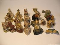 Photo showing the full set of 22 porcelain figurines, including Nursery Rhyme characters and animals, arranged on a flat surface.