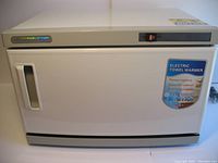 Front view of white towel warmer with on/off switch and label indicating electric towel warmer.