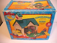 Box front showing the Arthur Schoolhouse set assembled with figures including school bus, slide, chalkboard and fence.