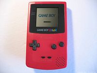 Front view of the red Nintendo Game Boy Color powered on displaying the Game Boy start screen.