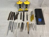 Full lot view showing all tools laid out, including Stanley chisel set with hand guards, punches, nail sets, and other small hand tools.