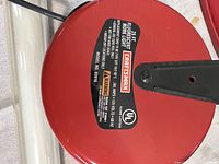 Close up of red Craftsman 25 ft work light cord reel label showing capacity and model number 83916.