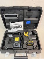 Open hard case showing inspection camera, battery, charger, cable and manual