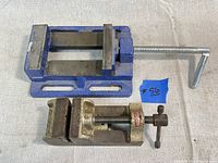 Top view of both drill press vices showing their size and structure on a plain surface.