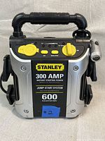 Front view of Stanley Jump Start It jump starter with label showing 300 AMP instant starting power and 600 peak battery amps with USB and battery status indicators