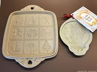 Square shortbread cookie mold showing nine Christmas motifs and decorative handles