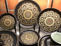 Overall view of dinnerware grouping showing plates on stands and stacked cups