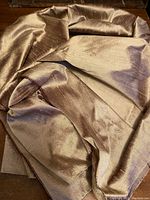 Photo of folded pale tea color silk fabric showing texture and sheen