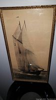 Full view of the framed black and white picture showing the Bluenose schooner under full sail at sea.
