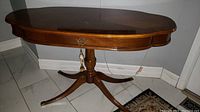 Full view of antique oval wooden sofa table in polished finish, showing the front drawer and overall shape.