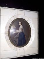 Oval miniature painting of a woman at a piano, identified as Jenny Lind, under convex glass with a white and bone inlay frame.