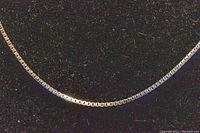 Close-up of the white gold box chain links showing the detailed square-shaped links and polished finish.
