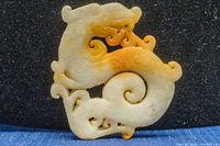 Front view of the jade dragon pendant showing detailed carving and color variation in the jade.