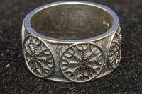 Close-up view of the ring band showing three raised circular panels each with an engraved Viking Vegvisir symbol.