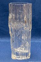 Front angled view of clear glass vase showing textured iceberg design and irregular top rim.