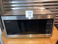 Front view of Panasonic microwave oven showing stainless steel finish and control panel.