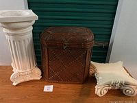 Full lot view showing both planter pillars and vintage hamper arranged on wood surface.