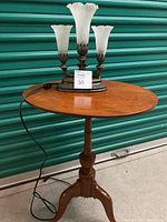 Side table with metal lamp on top, showing the whole items and scale.