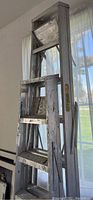 6-foot Keller metal step ladder with paint marks and visible wear