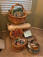 Vintage wooden and leather bench with multiple sewing supply containers on the floor nearby