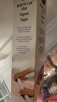 Photo showing Roll-N-Cut baking mat in box with usage instructions visible