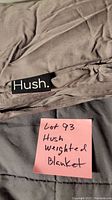 Close-up of Hush brand label on the weighted blanket's fabric.